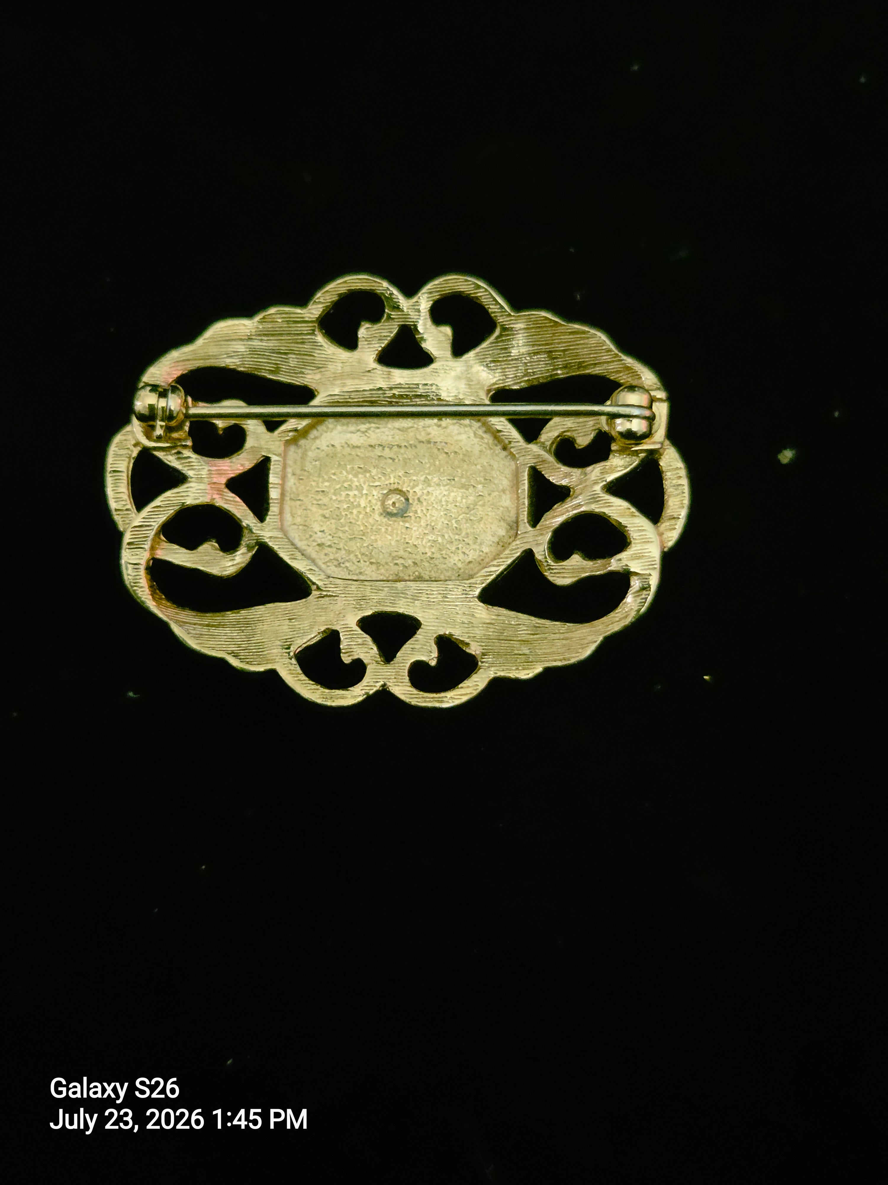 Elegant goldtone brooch with vibrant faux amethyst